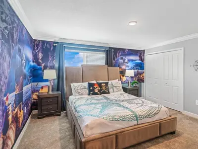 a bedroom with a large bed with a wall mural at Gorgeous Condo Close to Disney w Private Pool BBQ - Themed Bedrooms Walk To Clubhouse in Kissimmee