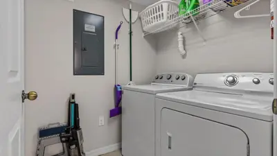 a small laundry room with a washer and dryer at bsv_villa8445 in Kissimmee