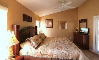 a bedroom with a bed and a television in it at Emma Castle - private fenced home 3 miles to Disney in Kissimmee