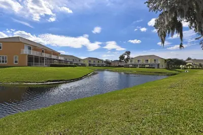a river in front of a building at Beautiful 3-Bed Villa 10 Minutes From Disney - Serenity Resort townhouse in Orlando