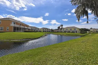 a river in front of a building at Beautiful 3-Bed Villa 10 Minutes From Disney - Serenity Resort townhouse in Orlando
