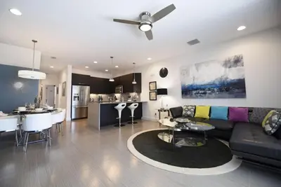 a living room and kitchen with a couch and a table at Beautiful 3-Bed Villa 10 Minutes From Disney - Serenity Resort townhouse in Orlando
