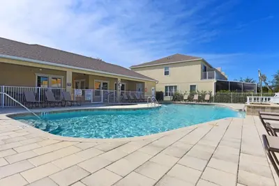a swimming pool in front of a house at 3 Bedroom Private Pool With Spa Near Disey villa in Orlando
