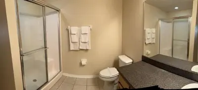 a bathroom with a shower and a toilet and a sink at 3 Bedroom Private Pool With Spa Near Disey villa in Orlando