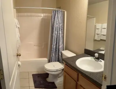 a bathroom with a toilet and a sink and a shower at 3 Bedroom Private Pool With Spa Near Disey villa in Orlando