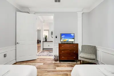 a bedroom with white walls and a tv on a dresser at Vista Cay Magic condo in Orlando