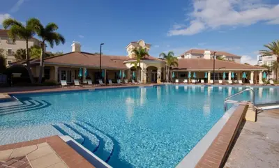 a large swimming pool in front of a house at NEW! Vista Cay Luxury Mirage condo in Orlando