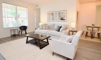 a living room with a white couch and a table at NEW! Vista Cay Luxury Mirage condo in Orlando
