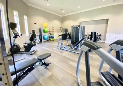 a gym with several treadmills and cardio machines at Vista Cay Electra condo in Orlando