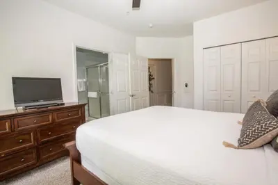 a bedroom with a bed and a tv on a dresser at Vista Cay Casa Bonita townhouse in Orlando