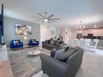 a living room with a couch and a dining room at 8 Bed Storey Lake Resort- Huge Bedroom for Kids home in Kissimmee