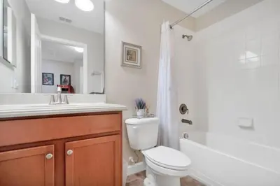 a bathroom with a toilet and a sink and a shower at Bismarck Palms home in Kissimmee