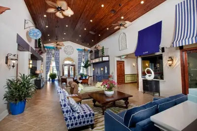 a large living room with blue couches and tables at Bismarck Palms home in Kissimmee