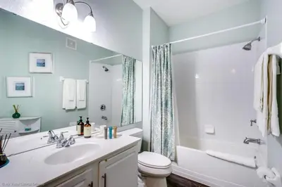 a bathroom with a sink and a toilet and a tub at Lake View 3 Bedroom In Vista Cay Resort condo in Orlando