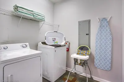 a laundry room with a washing machine and a tie at Lake View 3 Bedroom In Vista Cay Resort condo in Orlando