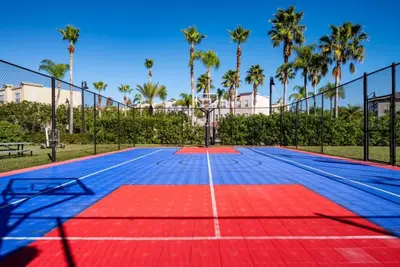 a tennis court with palm trees in the background at Lake View 3 Bedroom In Vista Cay Resort condo in Orlando
