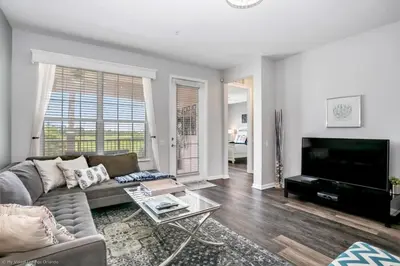 a living room with a couch and a flat screen tv at Lake View 3 Bedroom In Vista Cay Resort condo in Orlando