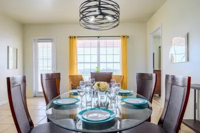 a dining room with a glass table and chairs at Pool View Penthouse condo in Orlando