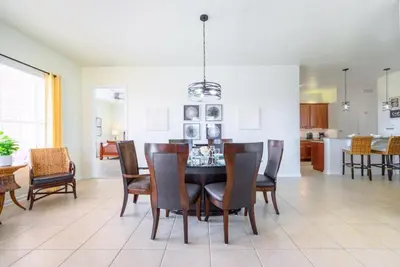 a kitchen and dining room with a table and chairs at Pool View Penthouse condo in Orlando