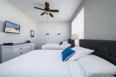 a bedroom with two beds and a ceiling fan at Vista Cay Casa Bella townhouse in Orlando