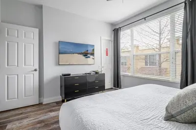 a bedroom with a bed and a large window at Vista Cay Casa Bella townhouse in Orlando