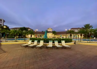 a row of white chairs sitting in a plaza at Vista Cay Casa Bella townhouse in Orlando