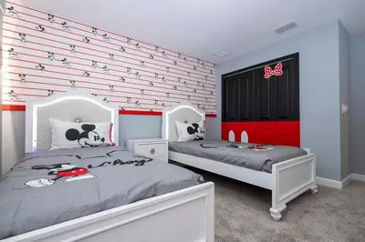 two beds in a bedroom with red and white stripes at Gorgeous 4Bd with Pool at Storey Lake Resort 4475 in Kissimmee