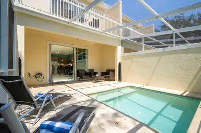 a swimming pool with two chairs and a balcony at Marvelous 3Bd w Pool Near Disney at Serenity 1536 in Orlando