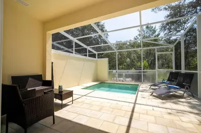 a swimming pool in a house with a glass ceiling at Marvelous 3Bd w Pool Near Disney at Serenity 1536 in Orlando