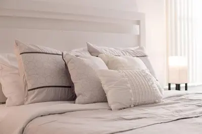 a white bed with a bunch of pillows on it at 606 - Stunning 5 bed vacation rental home with private pool in Kissimmee
