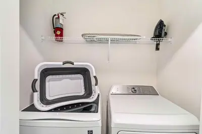 a small refrigerator with a microwave and a stove at 4423 Scene Lane in Kissimmee