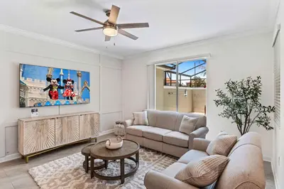 a living room with a couch and a ceiling fan at 4423 Scene Lane in Kissimmee