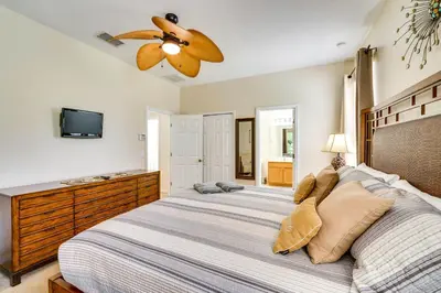 a bedroom with two beds and a ceiling fan at 10 Mi to Disney Home with Game Room and Lanai! in Kissimmee