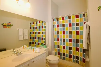 a bathroom with a toilet sink and a shower at Vista Cay Luxury Loft in Orlando