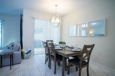 a dining room with a table and chairs at Relax in Ultimate Comfort with Pool & BBQ Area in Kissimmee