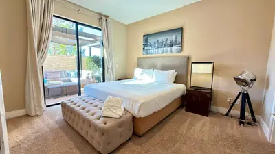 a bedroom with a bed and a large window at Sophisticated 4 En Suites w Private Hot Tub & BB in Orlando