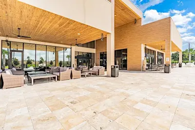 an outdoor patio with couches and tables and chairs at Sophisticated 4 En Suites w Private Hot Tub & BB in Orlando