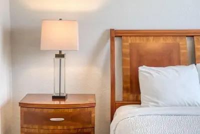 a bedroom with a bed and a lamp on a night stand at Vista Cay Luxury 3BR Condo in Orlando