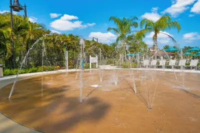 a water fountain in a park with palm trees at Luxury Lake View Condo-Vista Cay in Orlando
