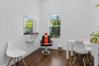 a white office with a desk and two chairs at Modern Family-Friendly Townhome – 10 Min Parks in Kissimmee