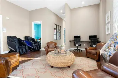 a living room with leather chairs and a table at Modern Family-Friendly Townhome – 10 Min Parks in Kissimmee