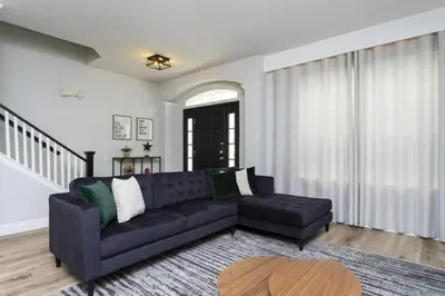 a living room with a couch and a table at Windsor Oasis 6BR Pool Game Room 9 min Disney in Orlando