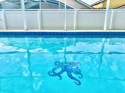 a octopus in the water in a swimming pool at Amazing Pool Spacious 3BR House near Disney in Kissimmee
