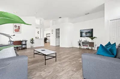 a living room with a couch and a table at Amazing Pool Spacious 3BR House near Disney in Kissimmee