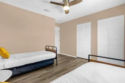 a bedroom with two beds and a ceiling fan at Amazing Blue Private Pool 4BR House Near Disney in Kissimmee