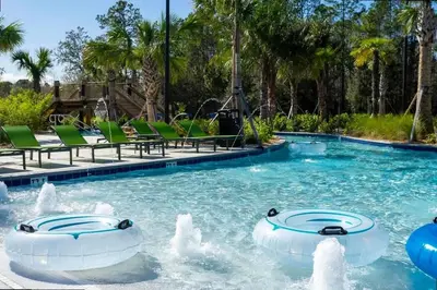 a pool at a resort with two rides at Splendid 5Bd Close to Disney at Storey Lake 4251 in Kissimmee