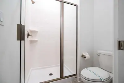 a bathroom with a shower and a toilet at Gorgeous 4 Bd w Pool at Storey Lake Resort 4277 in Kissimmee