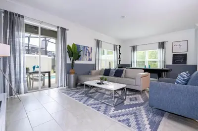 a living room with a couch and a table at Gorgeous 4 Bd w Pool at Storey Lake Resort 4277 in Kissimmee