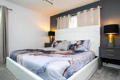a bedroom with a large bed and a window at Gorgeous 4 Bd w Pool at Storey Lake Resort 4277 in Kissimmee