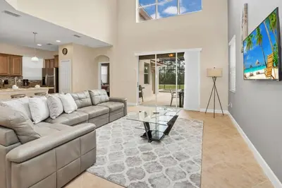 a living room with a couch and a table at Near Disney - 5BR Home- Games Pool Hot Tub & BBQ in Kissimmee